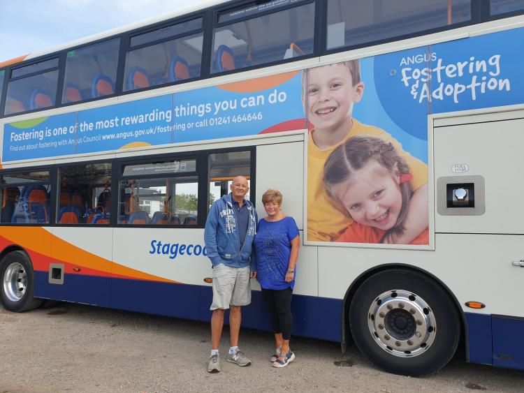 foster carers Jim and Lorraine beside one of the new bus adverts