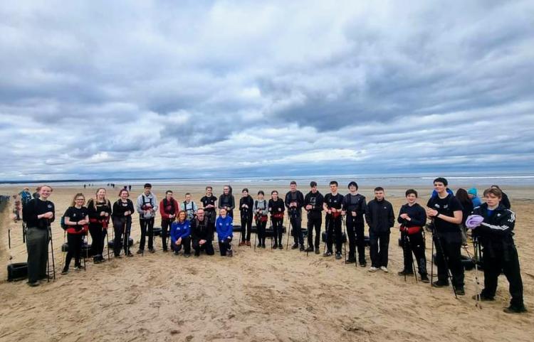 Young people from Arbroath High School and Monifieth High School with two teachers and Polar Academy staff on a beach about to train for an expedition