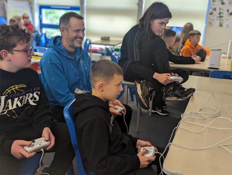 Teacher and young people at Seaview Ramsey McKay P7, Theo Whyte P7, Connell Considine-Davies P7 and Mr Richard Milne PSA
