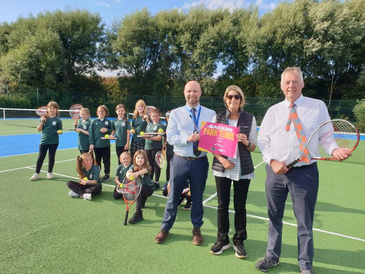 Cllr Mark McDonald, Cllr Kenny Braes, Kris Henderson (Law Tennis Association) with children from Ladyloan Primary school at new tennis courts in West Links, Arbroath