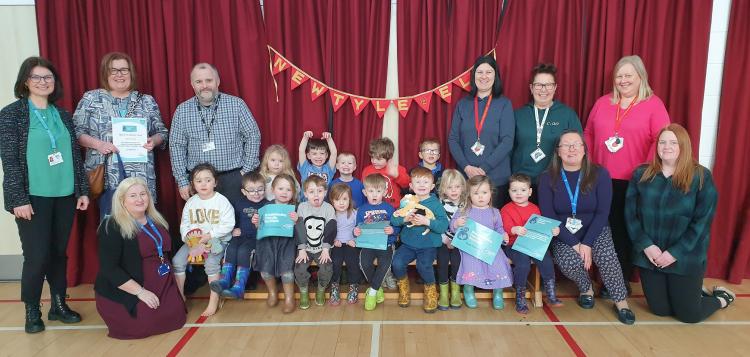 Photo of Newtyle Nursery staff and children receiving their award with Jenny Gillespie and Veronica Patullo, Public Health Directorate with Paul Kinney, Head Teacher Newtyle Primary School and (front left) Karen Lyndsay, Angus Council Locality Early Years Co-ordinator