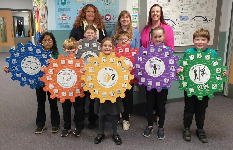 Head Teacher Strathmore Primary School - Jennifer Garnes, Angus Council’s Convener of Family, Education and Justice - Cllr Heather Doran and Strathmore Primary School’s Principal Teacher – Laura Marr, with children from the school with the seven emotion work cogs.